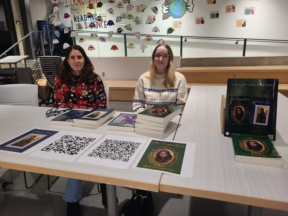 Leah Randall Vest and Hannah Vest signing books.